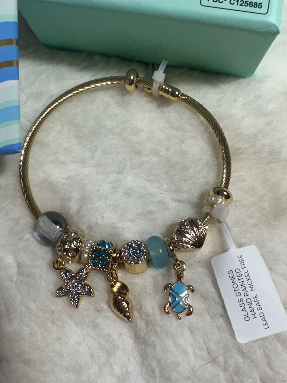 Piper K charm bracelet features hand-painted glass stones ocean-themed charms.